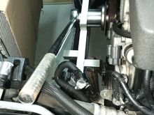 Crankshaft bolt removal tool. The free end is supported in the forked end of steel bar.