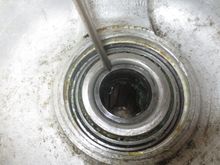 In this snap, the pointer is on the inside end of the hub tube, that rotates with the driveshafts and into which the splined end of the driveshaft goes. 