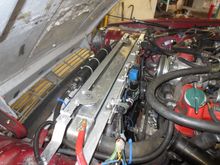This shows the fabricated radiator top support, and the cross strut supporting the electric fan chassis. The fans can be removed as a unit on their chassis as a unit very quickly. The temporary fix for the aircon dryer has now been replaced with giant stainless P clips attached to brackets on the support panel.