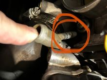 It comes out below the throttlebody