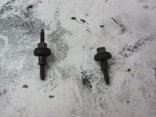 The two different styles of bolts that keep the cover on the cylinder head. They all have grommets. The manual says to replace all the grommets.