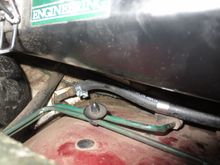 Note, the hose should go trhough the OEM wing clip to keep it well away from the exhaust, and forward past the exhaust before curving up to the front end of the engine
