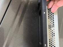 Lift up to clear the metal tabs that catch on the black plastic on the top