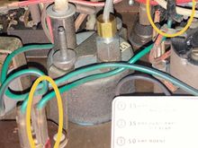 Note the ring terminal on the green wire. It's midway on a green wire, between the regulator and where that green wire goes into the fabric-covered harness. 