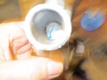 Sorry about the focus, the arrow points to a just-visible hole that leads down to the idle speed adjuster canal. The bung needs to be downstream of this hole.