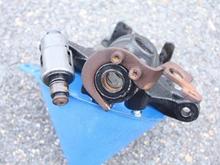 If you look at the collar of the actuator and the matching surface of the caliper body, you can see all the rust that is the issue.  All if this needs to be removed.  You should be able to put the two pieces back together and move them with your hand when you are done.  Do not forget to lube them to prevent future problems.
