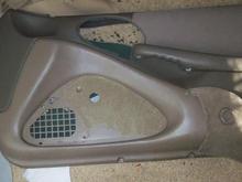 Fabric removed from lower portion of panel (speaker cover)