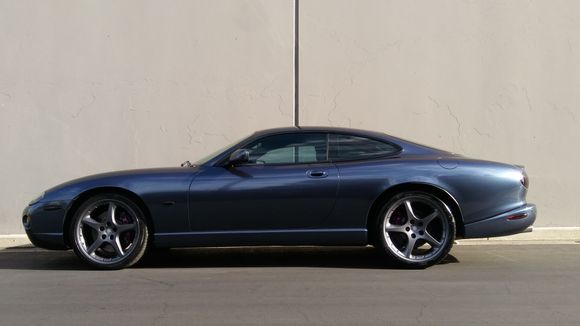 the color is Gloss Glacier Grey by 3M 1080
It is color change, meaning the front end of the car is in the shade, and appears as a glossy greyish blue black.  When the sun hits it,  it is metallic as seen on the boot area.  BBS wheels are gloss metallic graphite grey, Brembos are metallic purple.