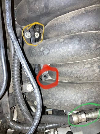 The red circle shows one of the four rubber grommets. 
The yellow circle shows a small part of the part load breather. You need to be careful removing this piece from the valve cover and back by the throttle body. The part load breather can and will break very easily if it’s original. 
The green circle is the fuel line return. Your going to need a few fuel line disconnect tools. They should have then at any auto parts store. 