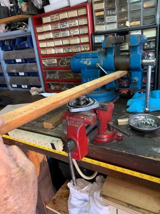 Pic shows how I used my red bench vise to secure the thermo housing and used a heavier blue vice as a pivot point to use the wood to compress the thermostat while twisting the wings under the tabs.