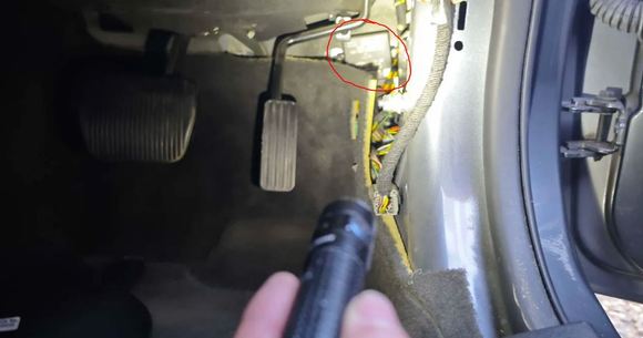 The module is located behind the accelerator pedal on my RHD XKR, secured with two 8mm bolts.