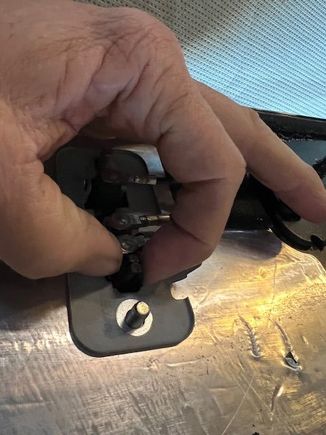 After removing the cables and the (2) 10mm stud nuts, you will see a pair of black tabs that must be squeezed together in order to allow the meatal base plate to be removed.  Once the plate is removed, your antenna unit will be free to replace. 