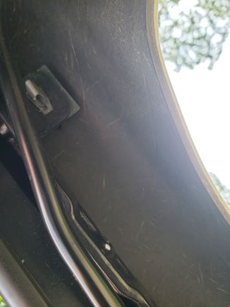 Push type fastener about 10" from the end-most fastener on the side cover.