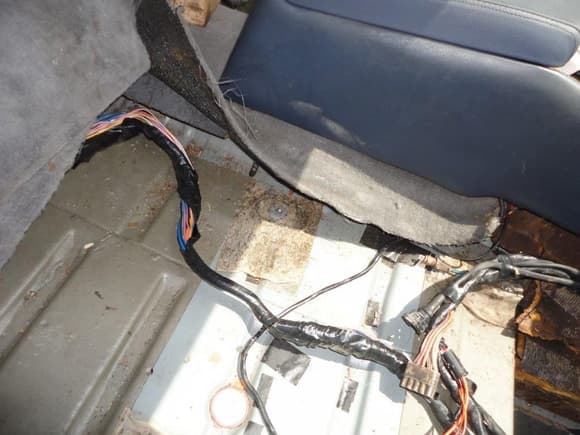 Wiring harness routed along the right side of the center console.