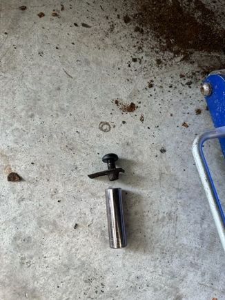 Bolt and captive nut. Debris is what was sitting in that recess.