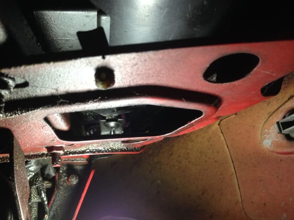 Completely remove Torx bolt from beneath headlamp.