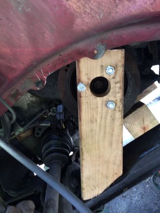 Here the tool I made from a piece of 2x4, I used a hole saw to cut a hole, I then drilled three small holes to put three bolts through, put it on the pulley, mark the subframe on other end of 2x4 then cut to the length and at the angle, tighten up the bolts to the sprockets, put the wrench through the hole and used all you mighty strength to turn the handle. It cost me a piece of scrap 2x4 and about $3 for the bolts