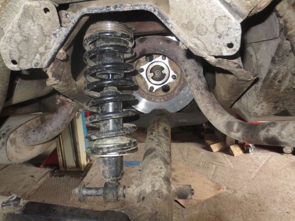 Access with the driveshaft, front shocker and lower wishbone disconnected