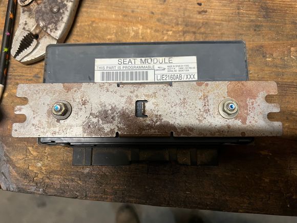 XK8 attaches by bolting metal bar to seat