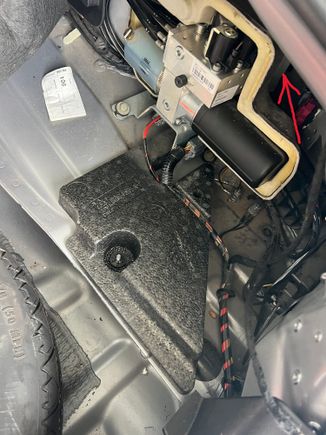 USB/Portable audio module is behind convertible top pump at arrow