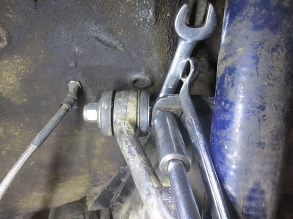 11/16th on nut, ring spanner to hold it against the torque, 5/8ths bolt head.
