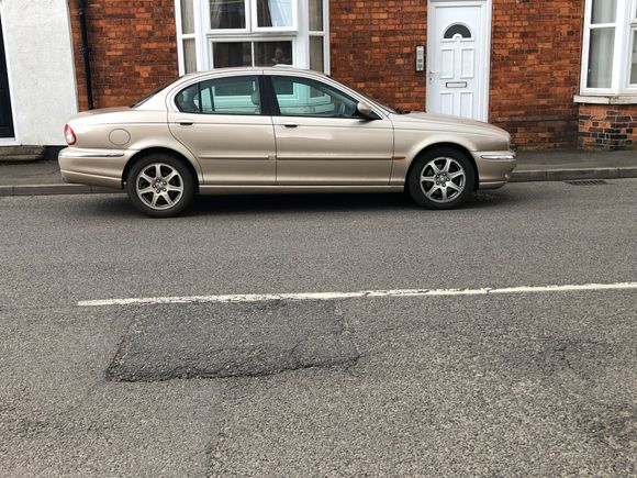 My X-type parked in a local village. I was told it was gold, but the DVLA call it beige which is very boring.