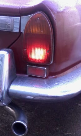 little square under tail light is reflector, right? no try change that bulb :)
these tail lights on with 'side lights' setting on