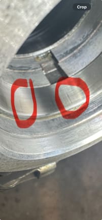 Close up of outer bearing race with vertical lines/impressions circled.