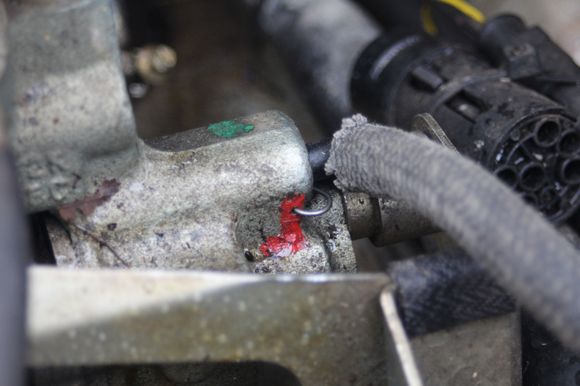 This is the Inlet of the Low Pressure Side of The Brake Pump that's the one with the Accumulator 'Black Ball'

That little Spring Clip held in Place with a dab of Red 'Loctite' needs to be pulled out (easy!) but don't lose it!