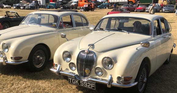 Two RHD S types with wipers parked to the right.