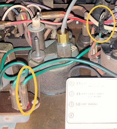 Note the ring terminal on the green wire. It's midway on a green wire, between the regulator and where that green wire goes into the fabric-covered harness. 