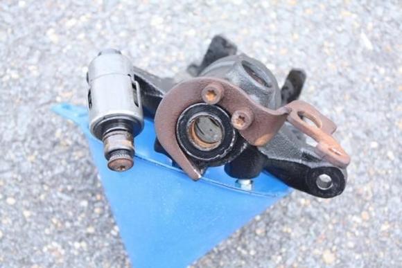 If you look at the collar of the actuator and the matching surface of the caliper body, you can see all the rust that is the issue.  All if this needs to be removed.  You should be able to put the two pieces back together and move them with your hand when you are done.  Do not forget to lube them to prevent future problems.