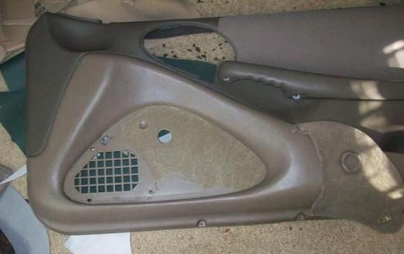 Fabric removed from lower portion of panel (speaker cover)