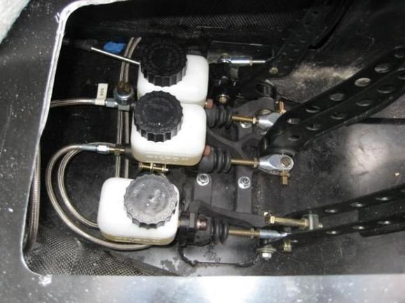 5 4
Here are the master cylinders from the top.  The cylinder at the bottom of the photo is the clutch, the center one actuates the rear brakes and the top is for the front brakes.  I must have put these pedals in and out of the chassis at least a dozen times over the past 4 years!