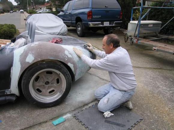 Still too rough for the carbon fiber skinthe dreaded bondo was applied generously to aid in the final contouring of the quarter panelfollowed by a LOT of sanding and mess making.  Clearly, all this sanding makes your hair begin to fall out...at least that is my theory and I'm stickin' to it!
