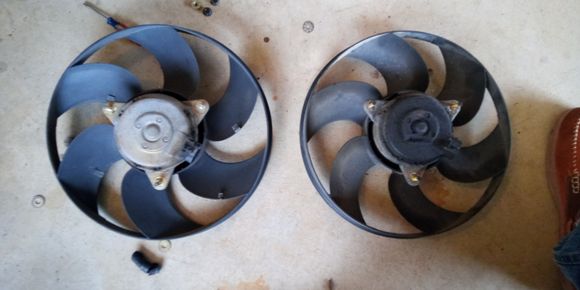 Three 10mm bolts hold the fan to the shroud.  The new one was dirty but was quiet.