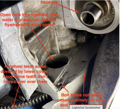 Missing flywheel cover behind oil filter.