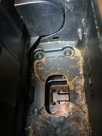 Here is what the cupholder bay looks like without the insert. Two screws at top hold the back of the ashtray. Note: the dried chocolate milk is an aftermarket option.