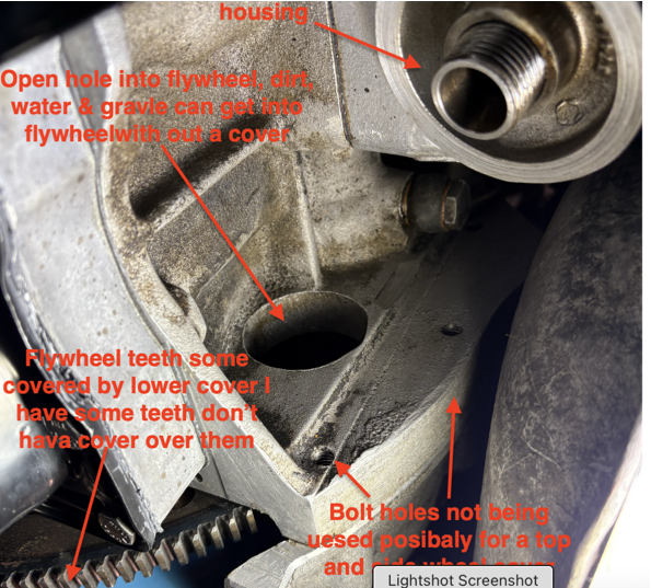 Missing flywheel cover behind oil filter.