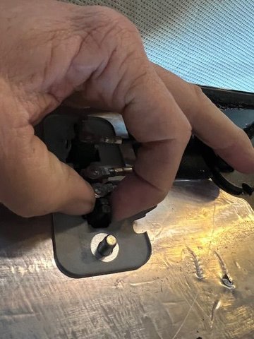After removing the cables and the (2) 10mm stud nuts, you will see a pair of black tabs that must be squeezed together in order to allow the meatal base plate to be removed.  Once the plate is removed, your antenna unit will be free to replace. 