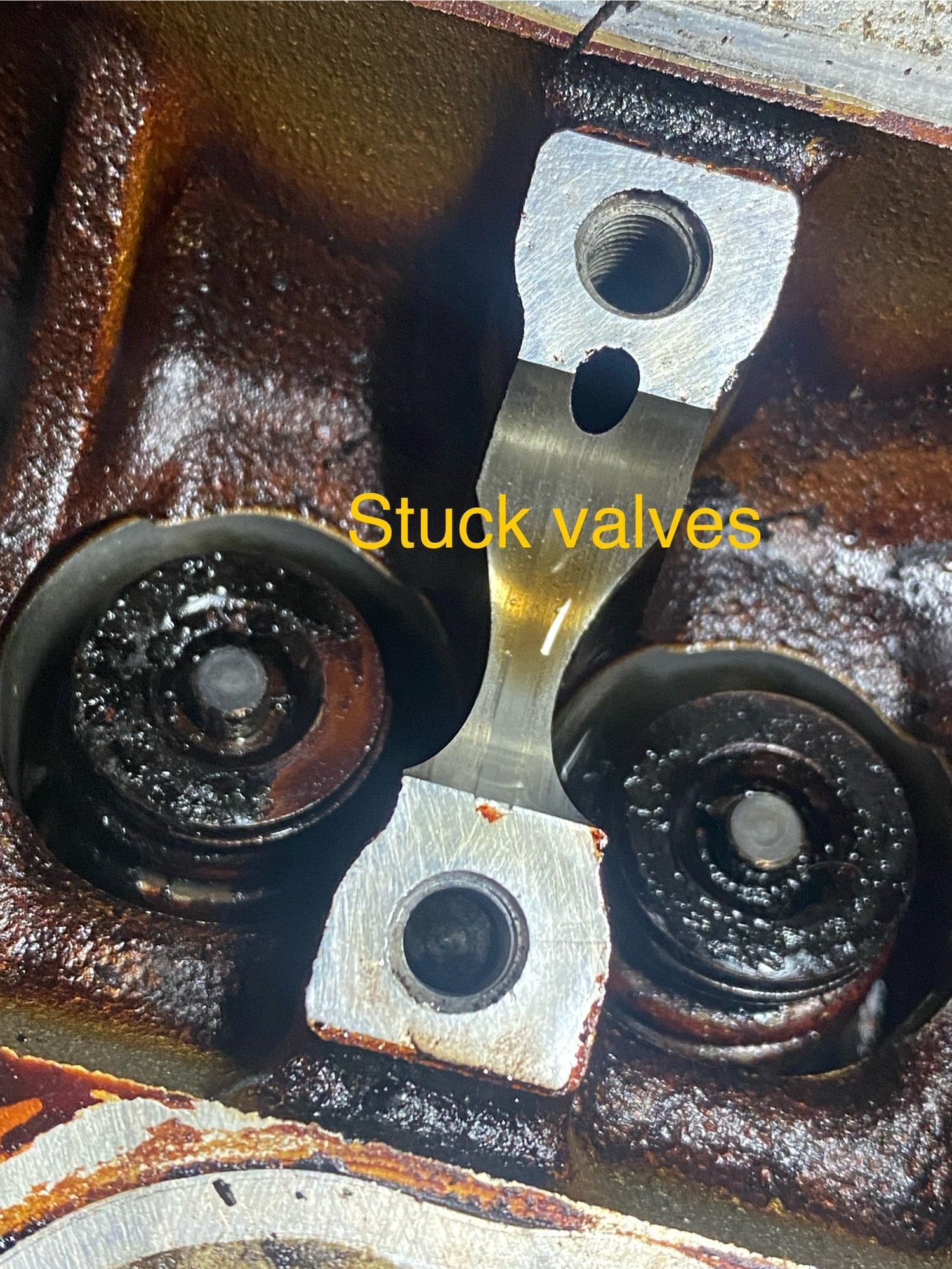 These are 2 photos of the #1 exhaust valve with the camshaft removed.  Besides being all burnt, I don�t see anything preventing the valve from fully closing.  I also boroscoped the inside of the cylinder with the exhaust valve fully open and I didn�t see any damage to the valve.  The engine rotates by hand freely without any resistance.  If the valve was bent, wouldn�t it make contact with the piston during rotation ?   