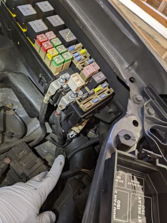 Disconnecting the two big wires and one connector from the main relay box.