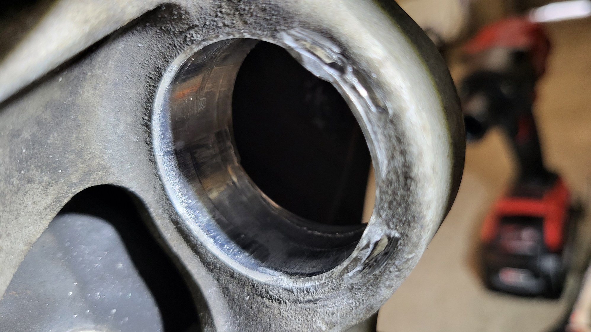 Majority of this carnage is from how I had to get the stuck bushing out. Temped to just press my backup new bushing in, but this wheel carrier is now compromised. 