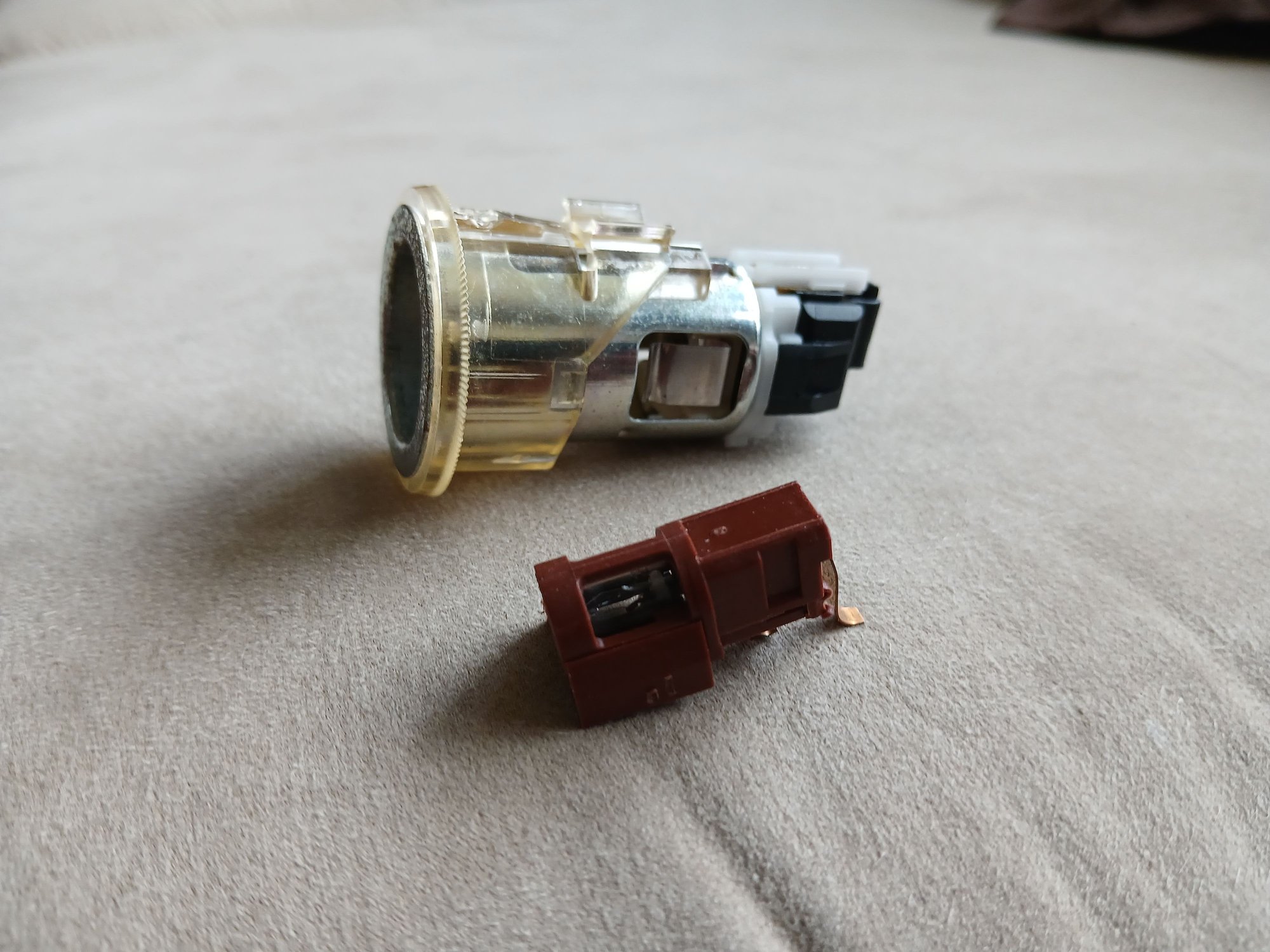 If so it is just a housing for a small light bulb. It snaps off fairly easily.