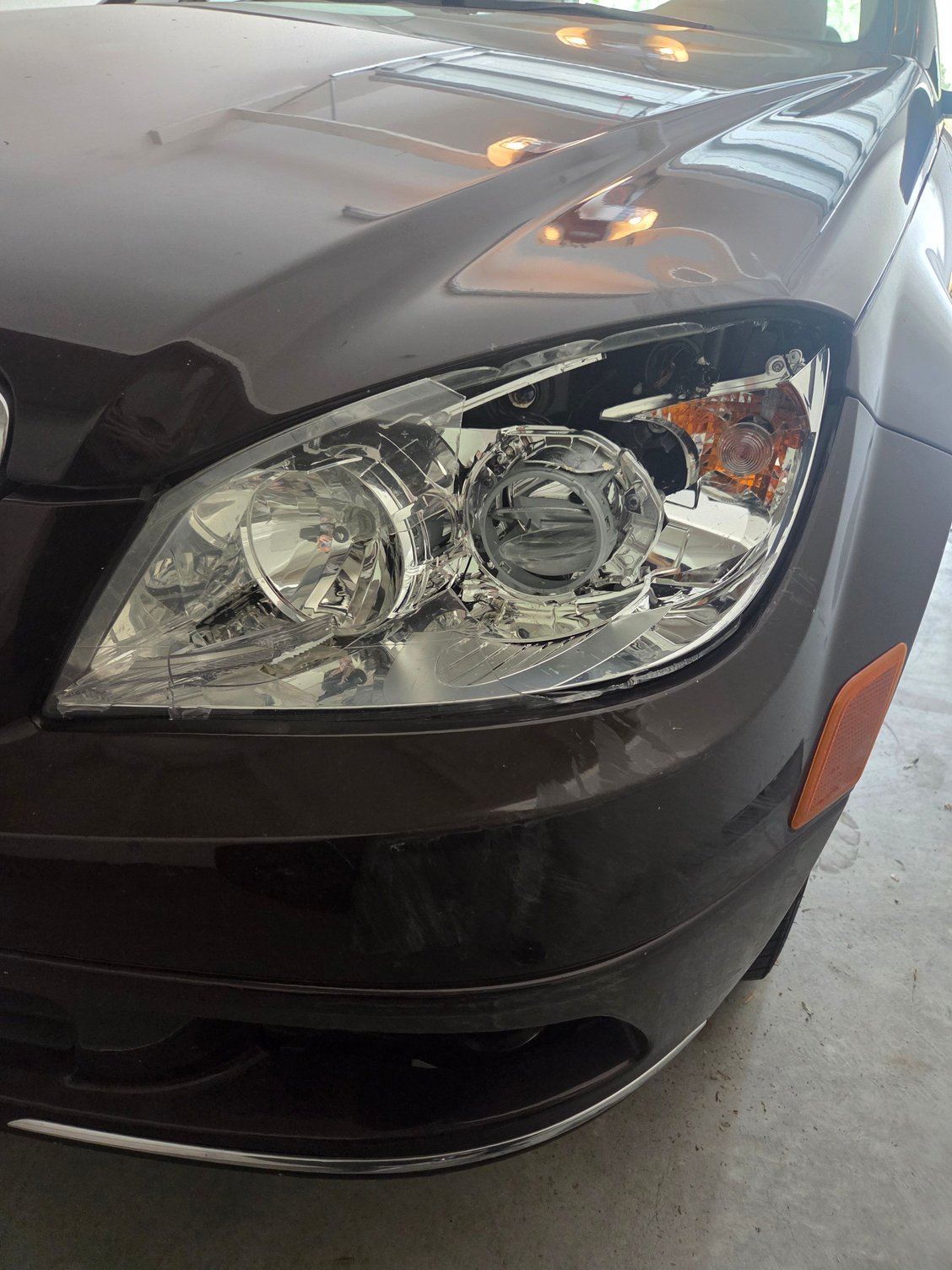 Smashed headlight. The little orange light to the right was lit while driving home after the damage. 