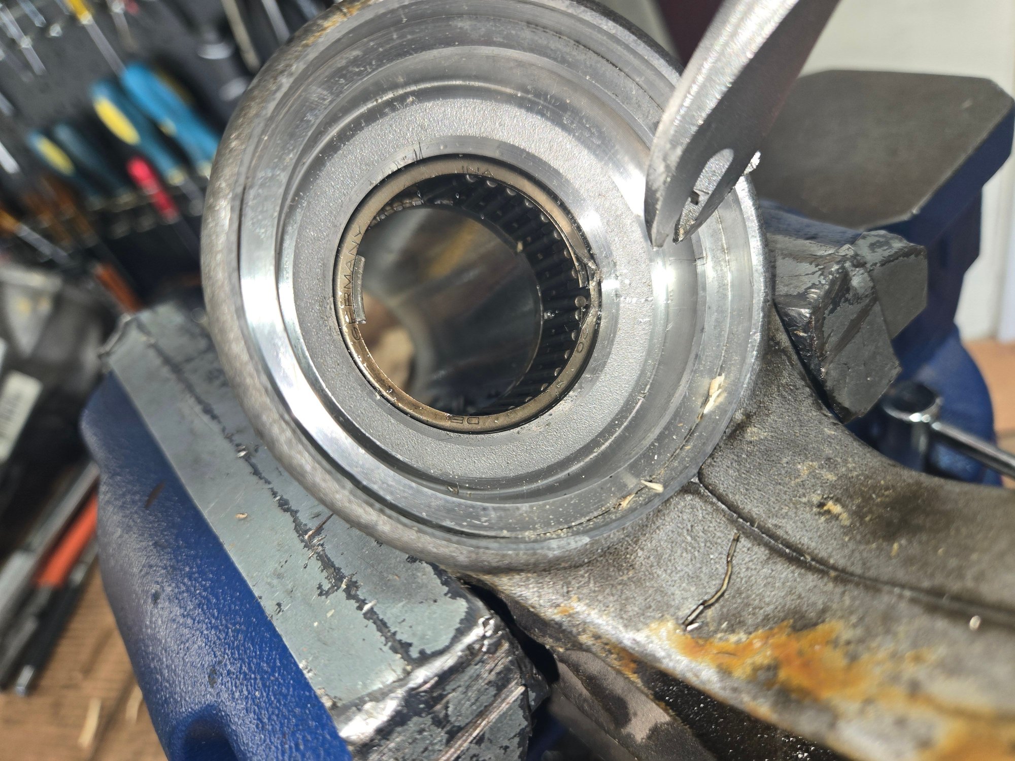 There's no edge on the needle roller bearing to push on to press it out. Break out the cage that holds the needles in place.