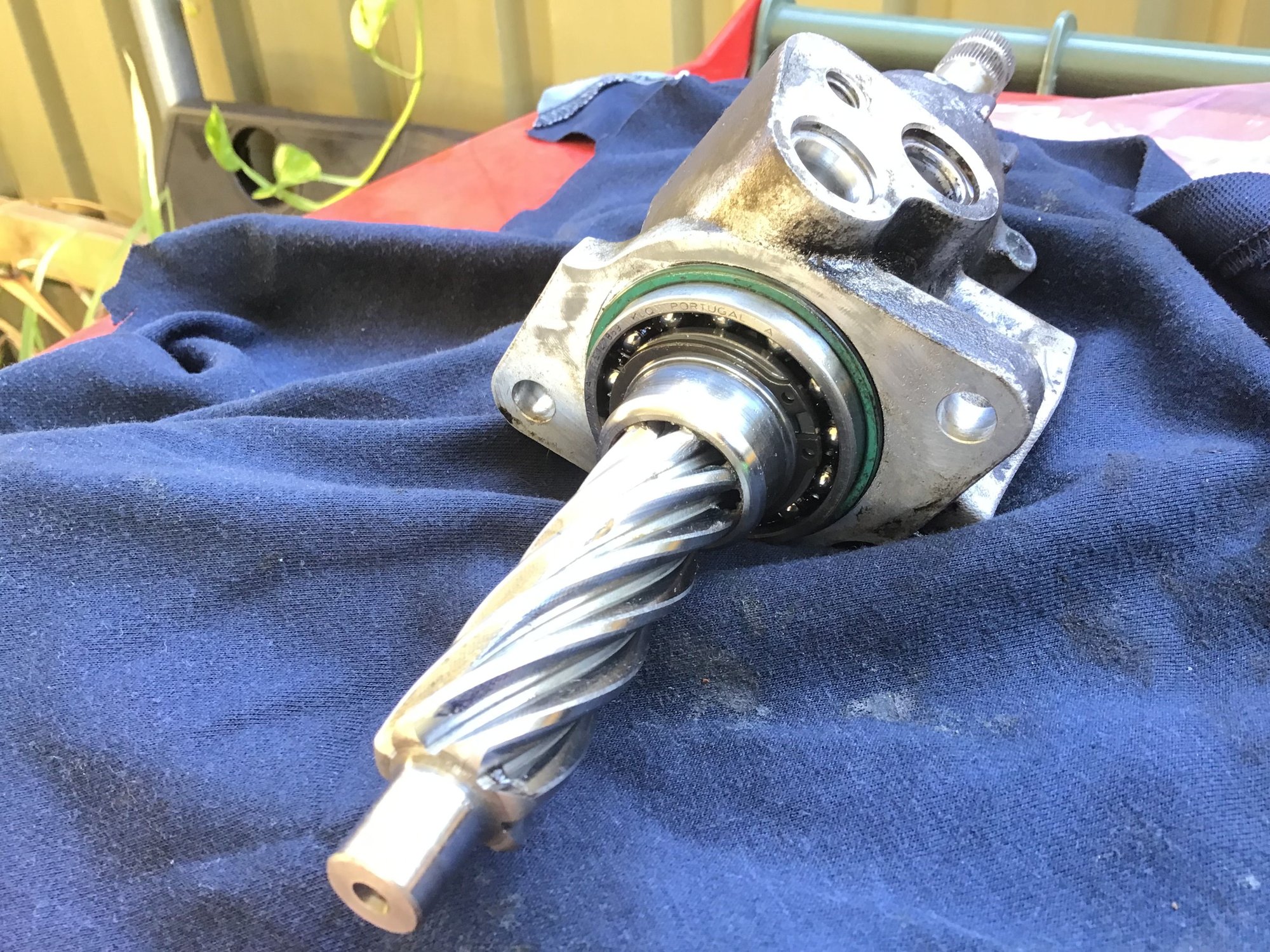 Circlip and bearing to remove first. Housing bolt-holes and pipe bracket bolt-hole can be seen here