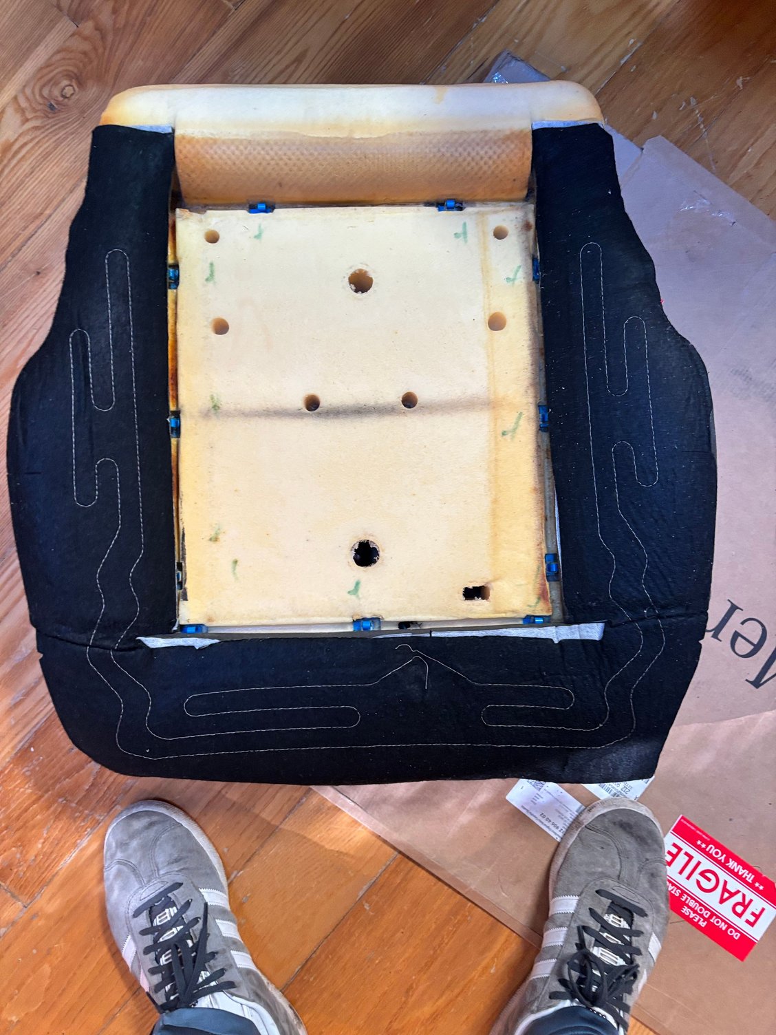 Installing the side seat heater element to the seat cushion.  The center heating element is enclosed in a pocket in the seat cover itself.