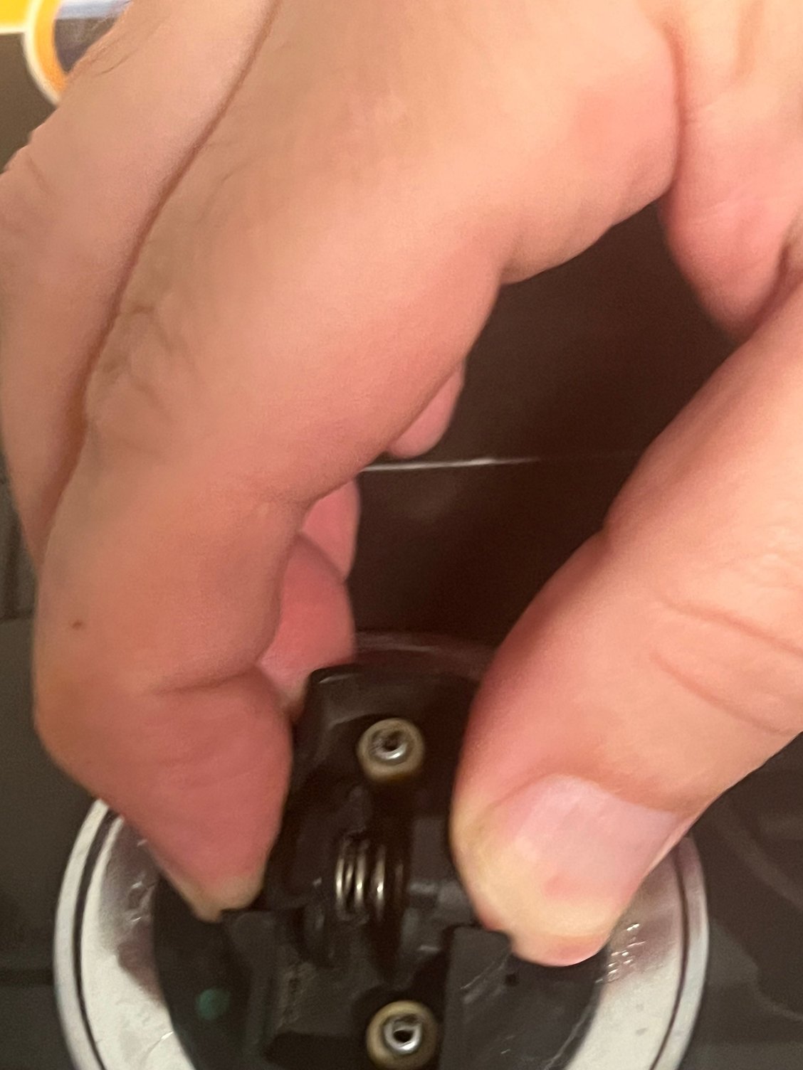 With the badge removed it is easy to compress the latch. 