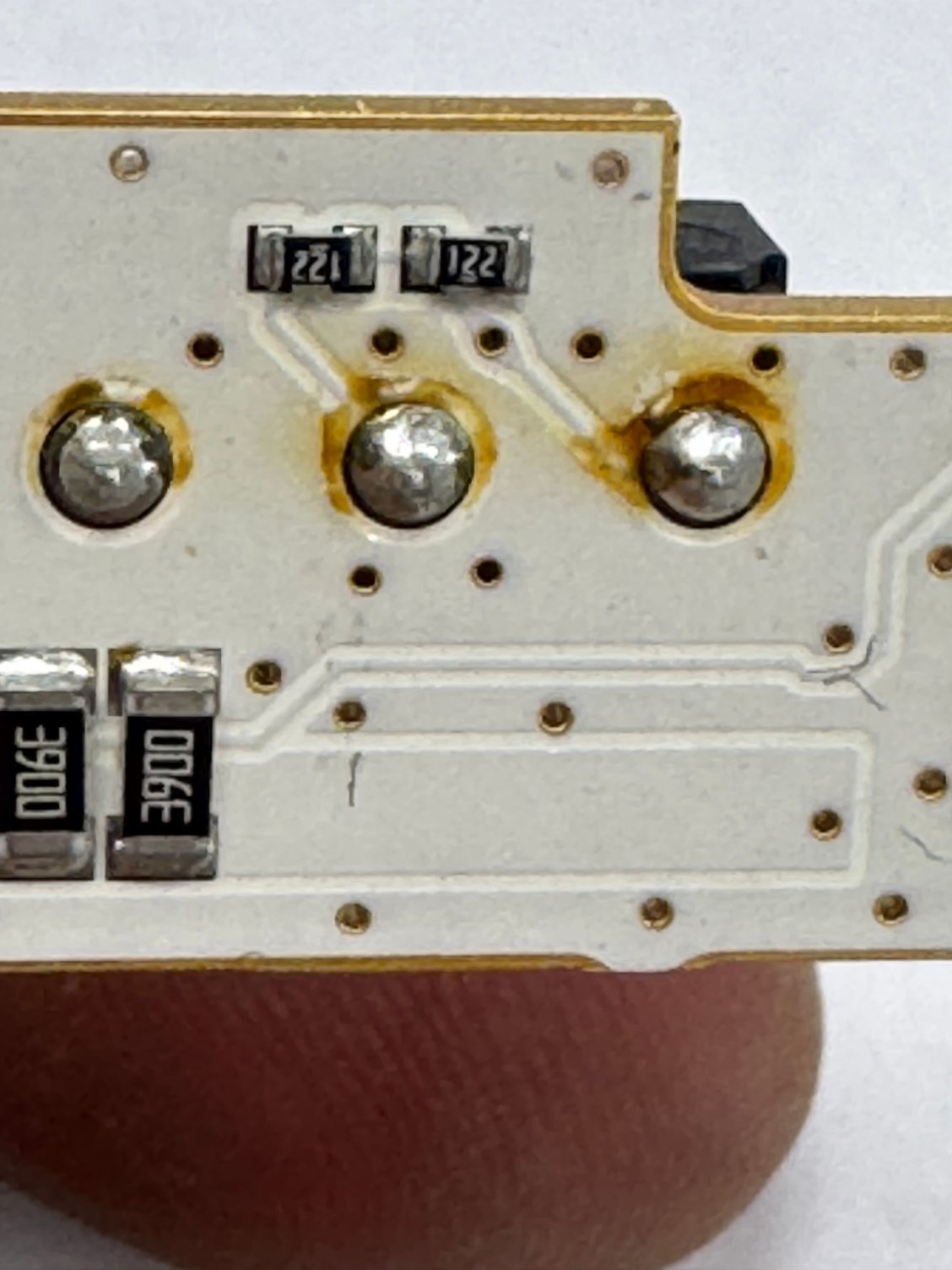 Solder joints under red switch